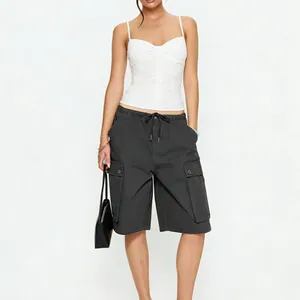 Detail of dark grey cargo shorts featuring an elastic drawstring waist and large side pockets