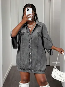 Detailed view of the washed gray denim shirt dress with oversized cut and vintage texture