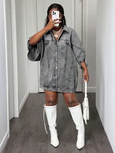 Detailed view of an oversized grey denim shirt dress featuring a button-down front