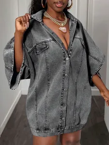Detail of dark gray washed denim vest with metallic buttons and vertical stitching