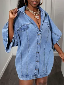 Detail of loose-fit blue denim shirt dress with classic collar and metal buttons