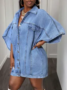 Detail of light blue oversized denim vest jacket with metal buttons and chest pockets