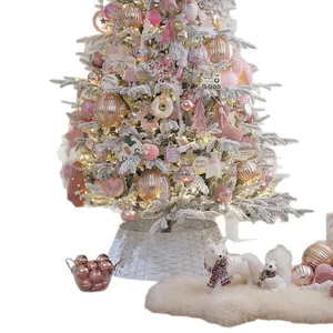 Elegant pink flocked Christmas tree set with ornaments and warm lights for home decor