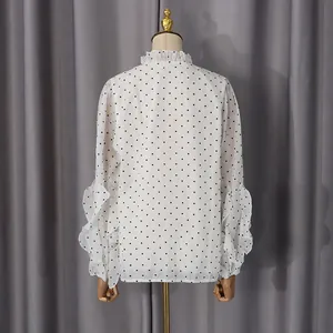 Detailed back view of white chiffon shirt with black heart print and ruffle accents