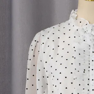 Detail of ruffle collar and heart print on white chiffon blouse for women