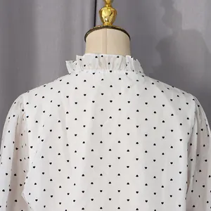 Detail of ruffle collar and black heart prints on white chiffon long sleeve shirt
