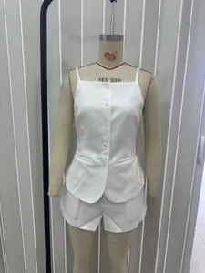 Detailed front view of white button-up camisole and matching shorts on a mannequin