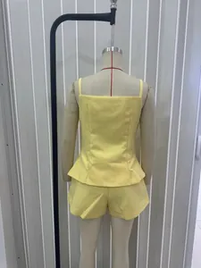Back view of lemon yellow two-piece set featuring a peplum camisole and high-waist shorts