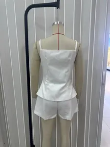 Rear view of white two-piece set featuring camisole top and matching mini shorts