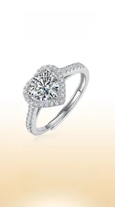 Close-up of heart-shaped moissanite center stone with halo setting on a 925 silver ring