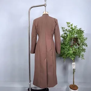 Deep brown wool coat featuring a stand collar and slim fit cut shown from the back