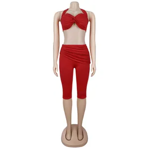 Detail of red halter top with twist front and matching high waist ruched leggings set