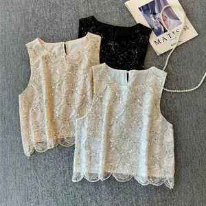 Three sequined sleeveless tops in gold, black and white featuring scalloped hem design