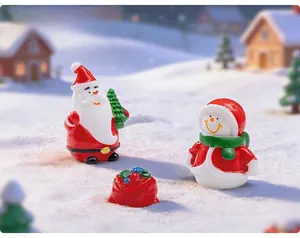 Close-up of resin Christmas figurines featuring Santa Claus and snowman on snow