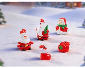 Detailed view of resin Christmas figurines including Santa, snowman, and gift boot accessories