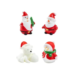 Set of four Christmas resin figurines featuring Santa, snowman, and a polar bear decoration