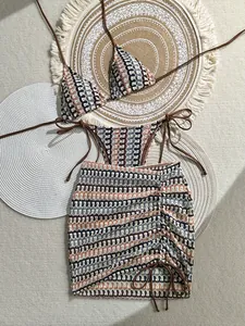 Detailed flat lay of a 3-piece bikini set with retro wave pattern and matching sarong skirt