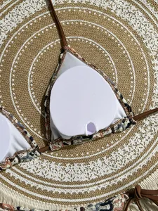 Detail view of the brown bikini top showing removable padding inserts and soft inner lining