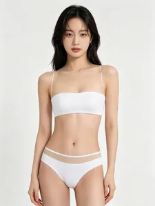 Detailed view of white seamless lingerie set with thin straps and sheer waist mesh panel