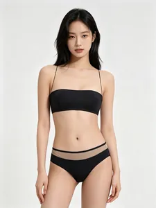 Detail of black seamless lingerie set with thin straps and sheer mesh paneling