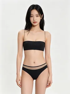 Front view of black seamless bra set with ultra-thin straps and sheer mesh paneling