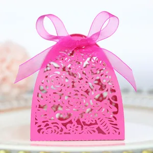Detail of laser-cut rose hollow candy box with matching pink chiffon ribbon bow