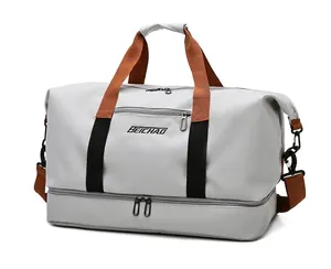 Large grey fitness travel bag with brown handles and a separate shoe compartment
