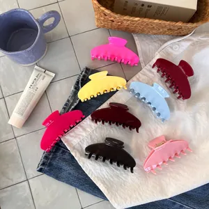 Set of large colorful acetate hair claws in jelly colors displayed on denim fabric