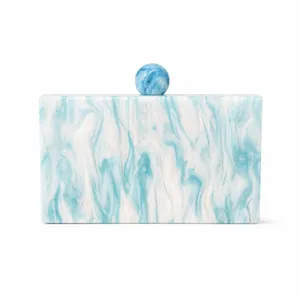Detail of blue and white marble acrylic evening clutch with spherical resin clasp