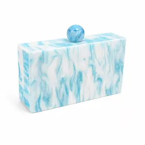 Close-up of rectangular blue marble acrylic clutch bag with a spherical top clasp