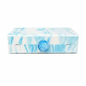 Detail of blue marble acrylic clutch showing the sphere lock and stone texture