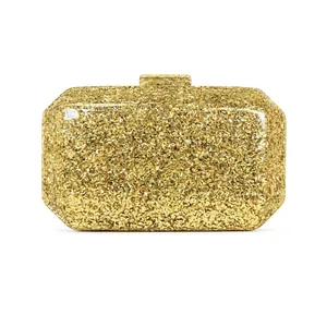 Elegant gold glitter evening clutch bag with rectangular metal clasp on white background