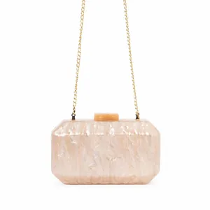 Macro detail of marble pattern acrylic evening clutch with gold metal chain strap