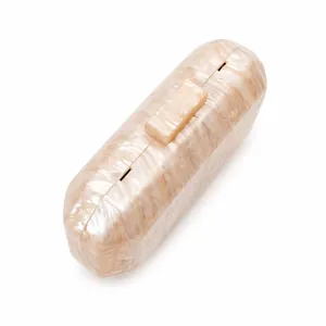 Macro view of elegant marble texture acrylic evening clutch bag with golden metallic clasp