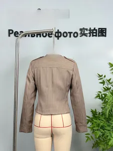 Detail view of brown pinstripe jacket featuring a stand collar and epaulet shoulder design