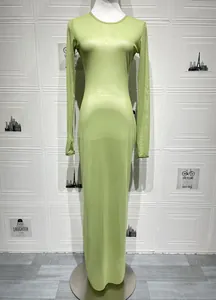 Close-up of semi-transparent light green mesh fabric and stitching on a slim-fit dress