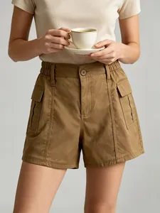 Detail of khaki high-waist cargo shorts with elastic waist and side flap pockets