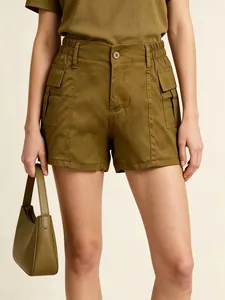 Detailed view of high-waisted olive green cargo shorts with large flap pockets