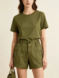Detail of olive green cargo shorts featuring elastic drawstring waist and large utility pocket
