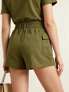 Detail view of military green high-waisted cargo shorts with flap pocket and elastic waist