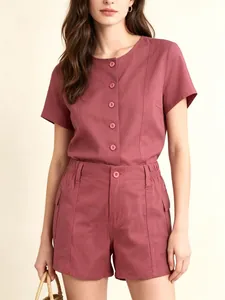 Detail of dusty pink short sleeve shirt with vertical stitching and cargo pocket shorts