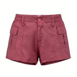 Detail of burgundy cargo denim shorts with elastic waist and large flap pockets