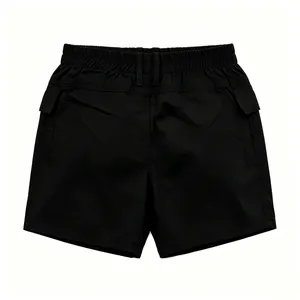 Detail of black cargo shorts featuring elastic waistband and side flap pockets