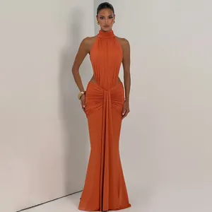 Detailed view of the side cut-out and draped pleated fabric on an orange evening gown