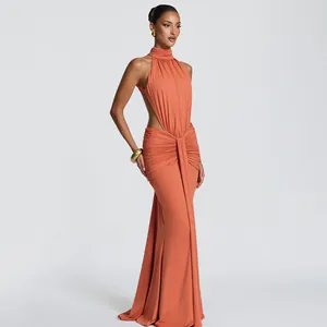Detailed view of elegant coral halter neck dress with draped waist pleats and slim fit