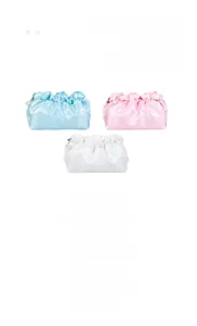 Close-up of pleated cloud makeup bags in satin fabric with elegant pearl zipper charm
