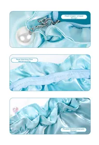 Detail view of light blue satin pouch with pearl zipper and refined pleated stitching