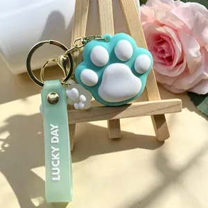 Cute mint green silicone cat paw keychain with Lucky Day strap and gold metal ring