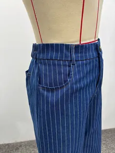 Detail view of navy striped denim pants with elastic waist and orange contrast stitching