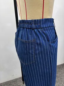Detail of high waisted striped trousers with contrast stitching and back pocket detail
